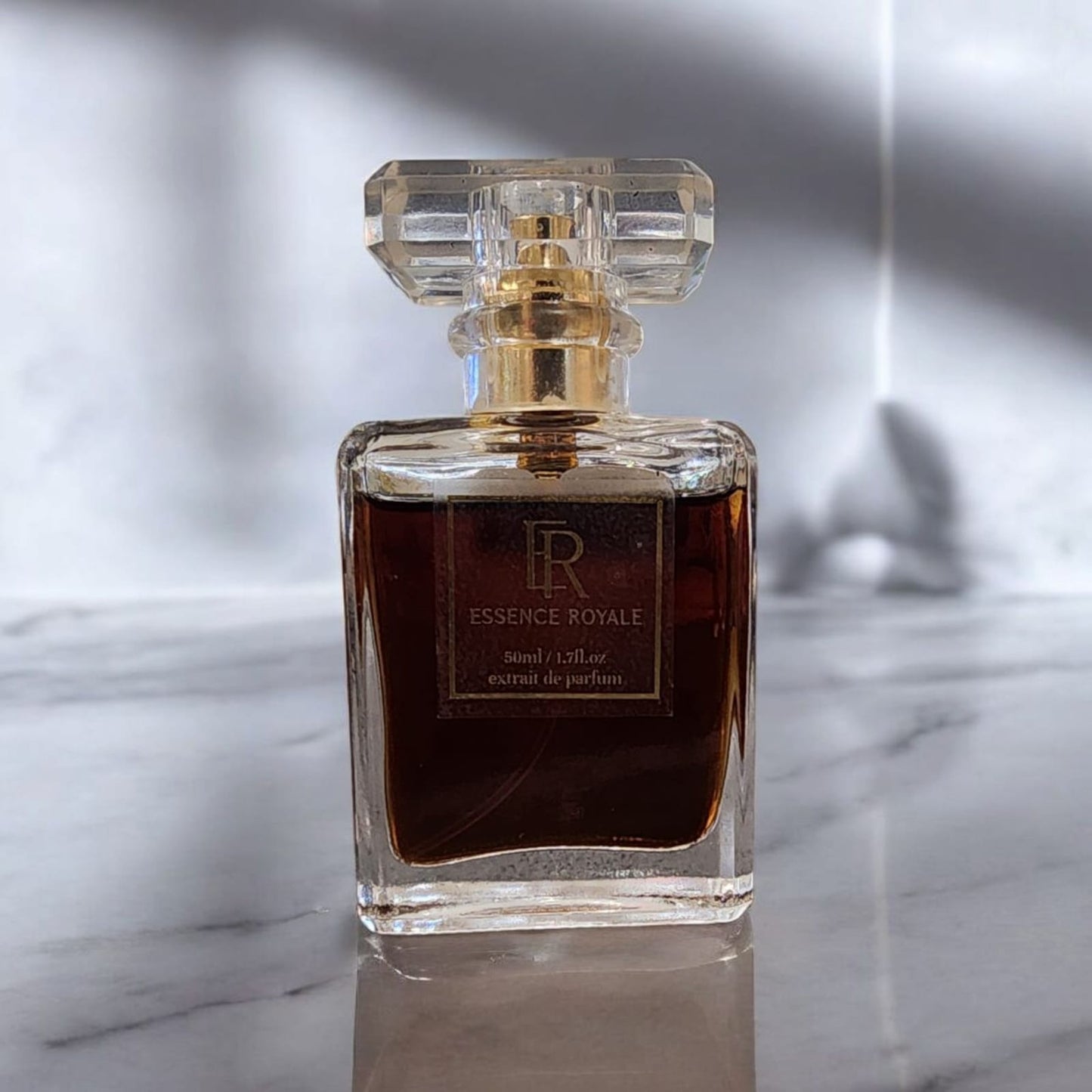 Cigar bottle surrounded by tobacco leaves and oud wood, evoking an opulent, earthy scent
